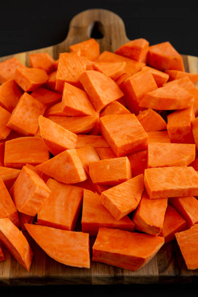istock Raw Chopped Sweet Potatoes on a Cutting Board, low angle view. 2201033618