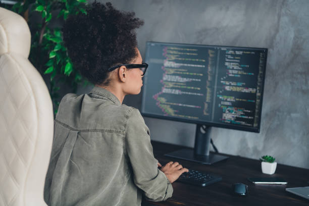 istock Profile side view portrait of attractive smart clever focused girl tech support writing editing css c++ at workplace workstation indoors 2201033956