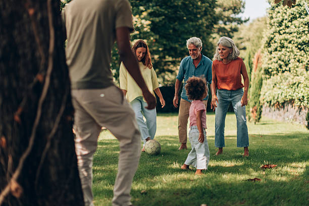 istock Multigenerational family playing soccer in the park 2201036522