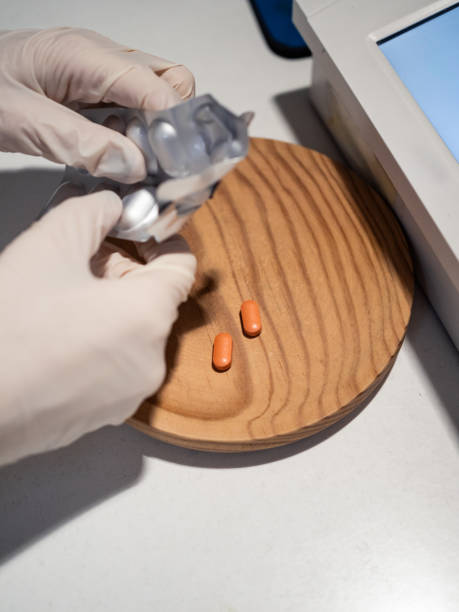 istock Hands of a pharmacist preparing medication in a pharmacy setting 2201040910