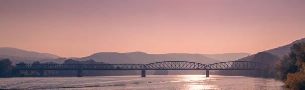 istock Scenic View of Bridge Over Danube River at Sunset 2201042478