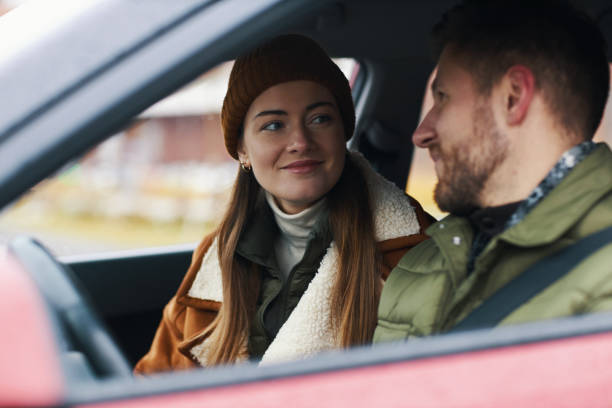 istock Smiling Couple Sitting Inside Car during Winter Day 2201043774