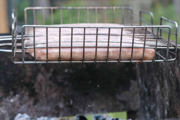 Sausages on the grill rack fried on charcoal