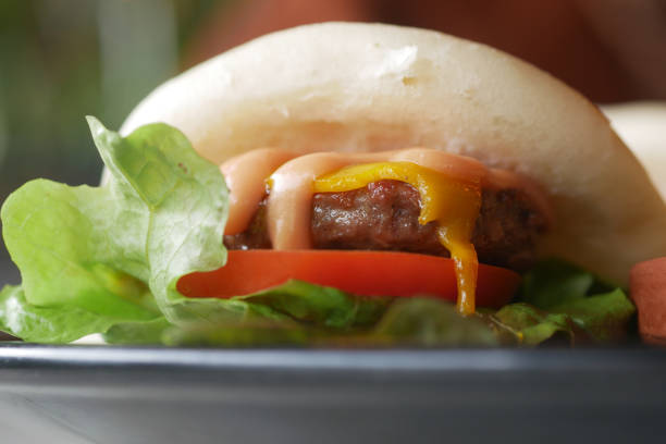 Delicious Cheeseburger With Fresh Lettuce and Tomato Close-Up View