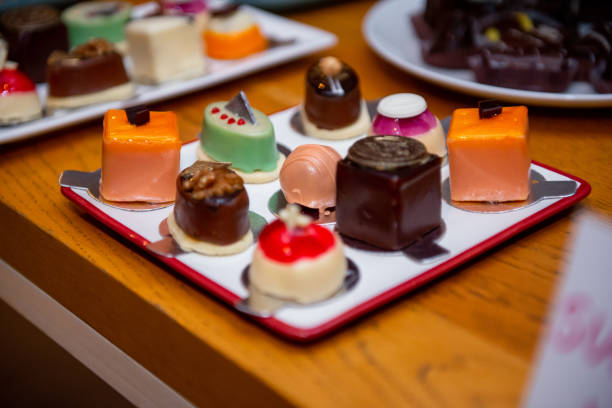 Delightful assortment of artisan chocolates displayed on a vibrant plate at an event dedicated to sweet treats during a festive gathering