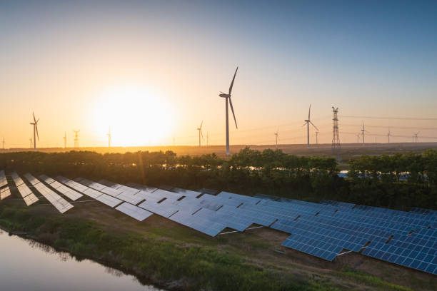 istock Solar power plants and wind farms at sunset 2201051576