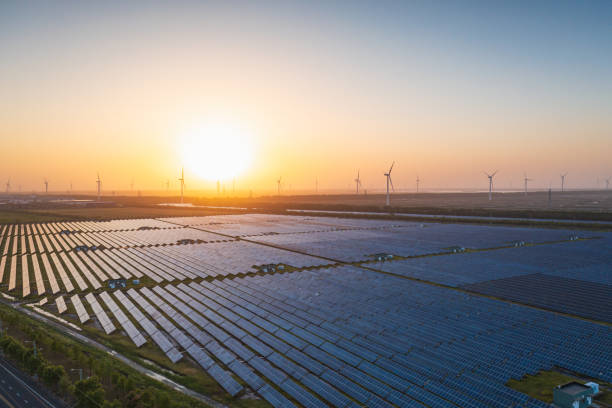 istock Solar power plants and wind farms at sunset 2201051593