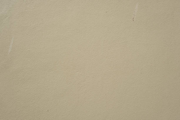 Fine-grained plaster applied by hand. Exterior plaster with space to copy. Warm colored blue background with the texture of rough grainy stone. High quality photo