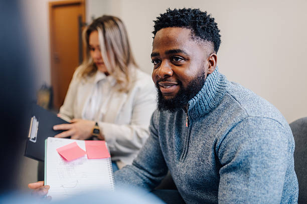 istock Young man participating in a business meeting, sharing ideas and brainstorming 2201056423