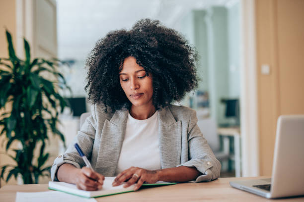 istock Successful businesswoman in modern office working on laptop. 2201058914