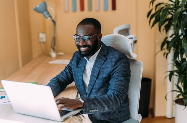 istock Successful businessman in modern office working on laptop. 2201058937