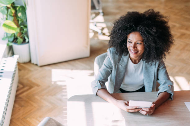 istock Successful businesswoman in modern office working on digital tablet. 2201058951
