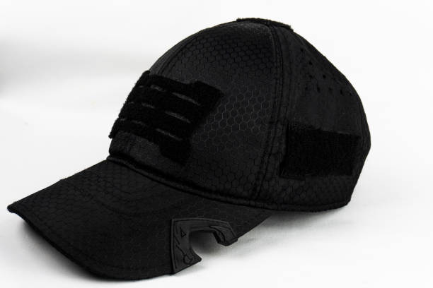 istock Angled view of a black tactical cap with a bottle opener feature, set against a clean white background. 2201066637