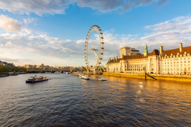 London, UK - 04 May 2024: London Eye (Millennium Wheel) and Thames river at sunset