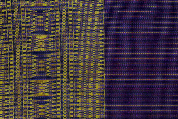 istock A vibrant textile featuring contrasting geometric patterns in gold and purple. The design showcases traditional weaving techniques and rich color palettes. 2201068326