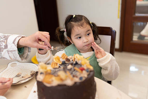 istock Little multiracial girl eating her breakfast 2201070982