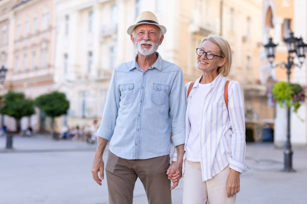 istock Elderly couple holding hands, enjoying a stroll on a sunny day. 2201073910
