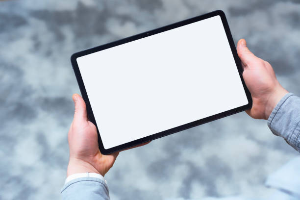 istock Mockup of modern tablet with white blank screen in hand. Concept for digital design and presentation. 2201074195