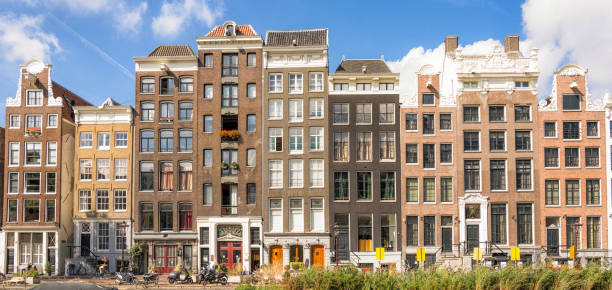 The facades of several traditional canal townhouses in Amsterdam, Holland.