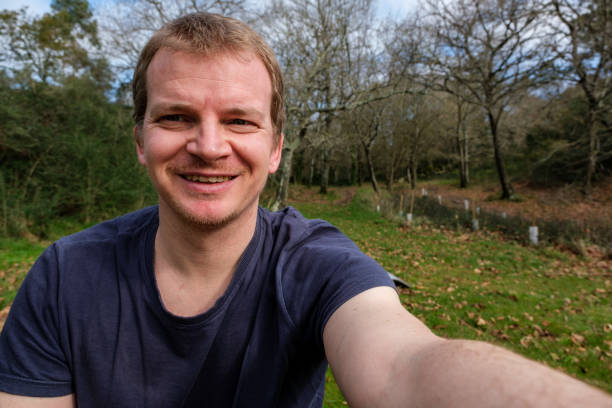 istock Smiling man taking a selfie in nature 2201076893