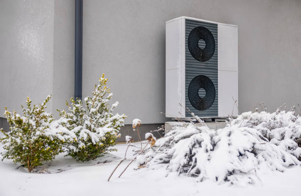 istock Outdoor heat pump unit covered with snow, providing energy-efficient home heating in winter. 2201077106
