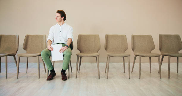 istock Waiting room, student and man with documents, chair and appointment for registration in university and knowledge. Education, candidate and opportunity for person in college, schedule and scholarship 2201077249