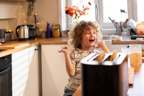 istock Little boy in the kitchen preparing a meal for himself 2201077608