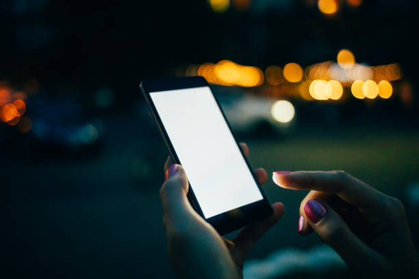 A person is holding a cell phone with a white screen