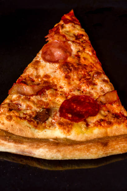 istock A piece of aromatic pizza on a baking sheet in the oven. 2201084723