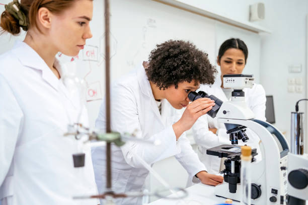 istock Diverse Female Students Collaborating in University Laboratory with Microscopes 2201085791
