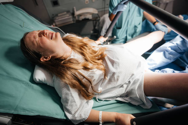 Woman in Active Labor Pushing During Childbirth in Hospital