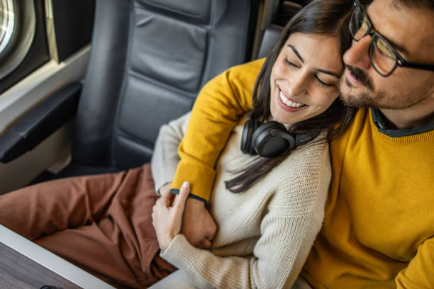 istock Couple sharing a warm embrace during their train journey 2201091973