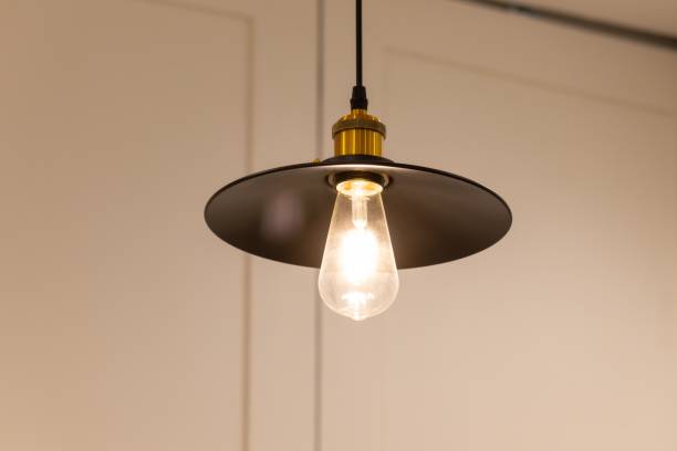 istock A light bulb is lit up in a black lampshade 2201092727