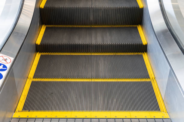 A escalator with yellow and black stripes