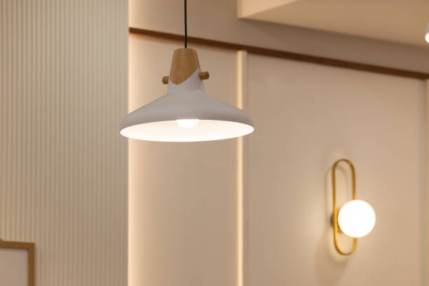 istock A white lamp with a wooden base is hanging from the ceiling 2201093176