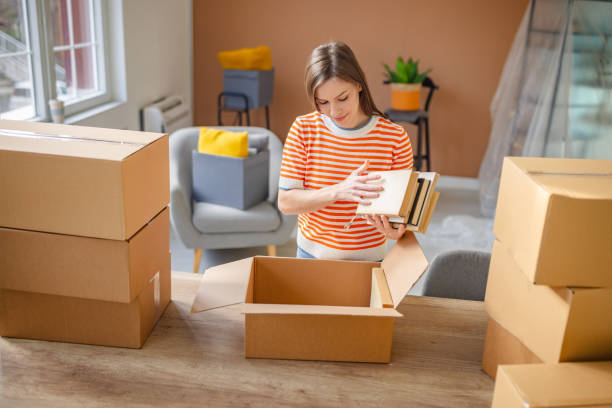 istock Young woman happily unpacking boxes in her new apartment while starting a fresh chapter in her life 2201094788