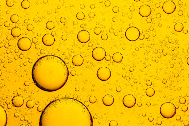istock Yellow Macro Drink Bubbles,Focus boiling yellow oil spread widely bubble texture full frame and macro many various droplets,Yellow fat, like obesity cells, under the microscope, is a chemical process of atoms and molecules. Close-up 2201094801
