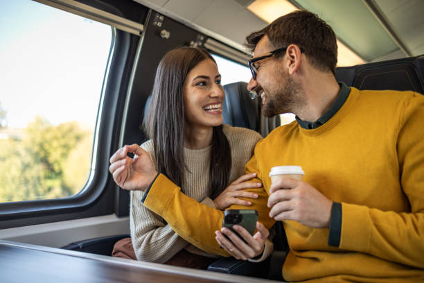 istock Man and woman chatting while traveling by train 2201096107