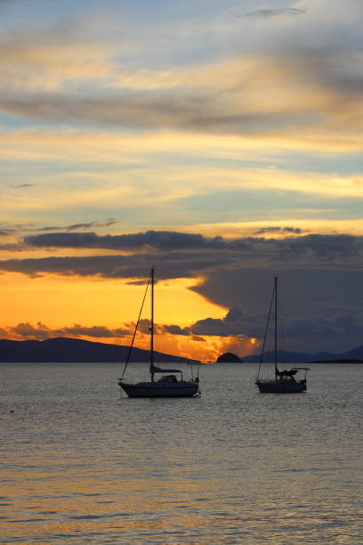 istock Alone sailboats at sunset. Atmospheric seascape with reflection 2201098508