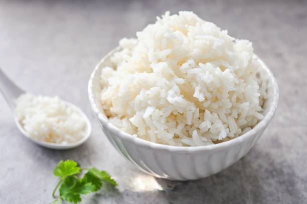 istock Cooked white rice or steamed rice in a white bowl 2201098580
