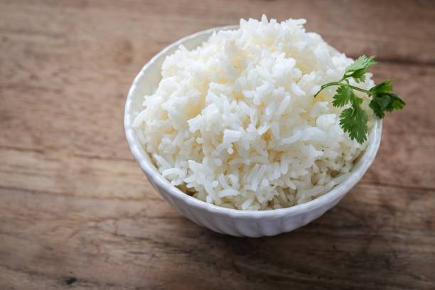 istock Cooked white rice or steamed rice in a white bowl 2201098585
