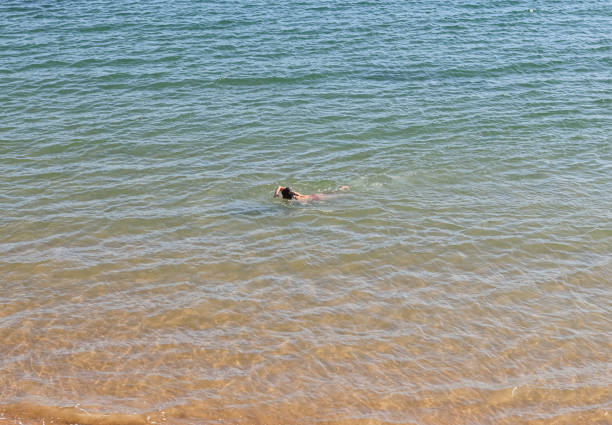 Woman swimming near the shore