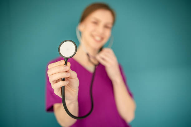 selective focus of stethoscope and cardiologist isolated on white. cardiologist with heartbeat in stethoscope at studio. stethoscope of cardiologist listen heartbeat. cardiologist
