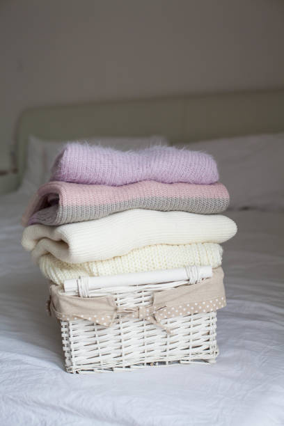 istock Basket with clean things on the bed. Cozy. Knitted sweaters. 2201102460