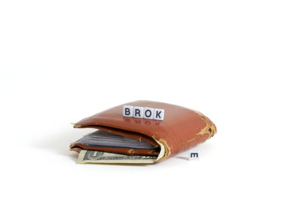 Gone broke, an old wallet with a single dollar bill on white. Text spelled out broke with the letter E falling over.