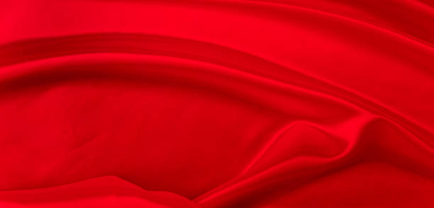 istock Black red satin dark fabric texture luxurious shiny that is abstract silk cloth background with patterns soft waves blur beautiful. 2201104023