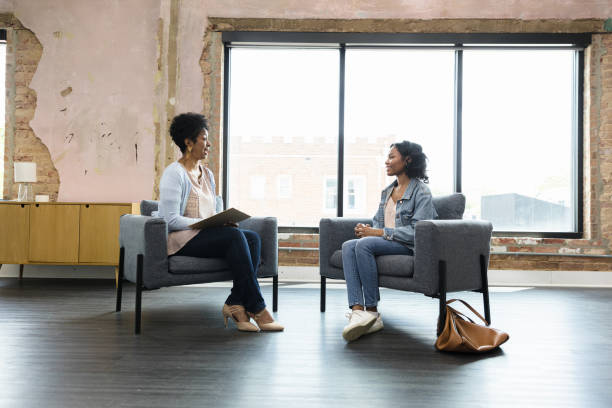 istock Two Women in Casual Clothing Having a Discussion 2201105371