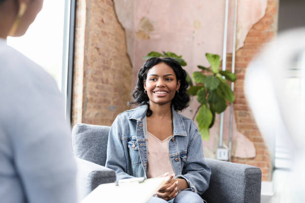 istock Confident Young Woman in Counseling Session, Smiling 2201105382