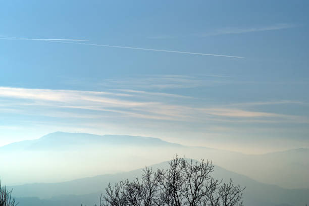 Passenger Jet airplane flying over clouds.
