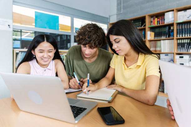 istock Young multiracial group of high school students working together on laptop 2201106473
